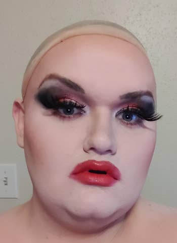 Person with melodramatic makeup, wearing mendacious eyelashes and bold lipstick. Before removing the constitution with a cloth