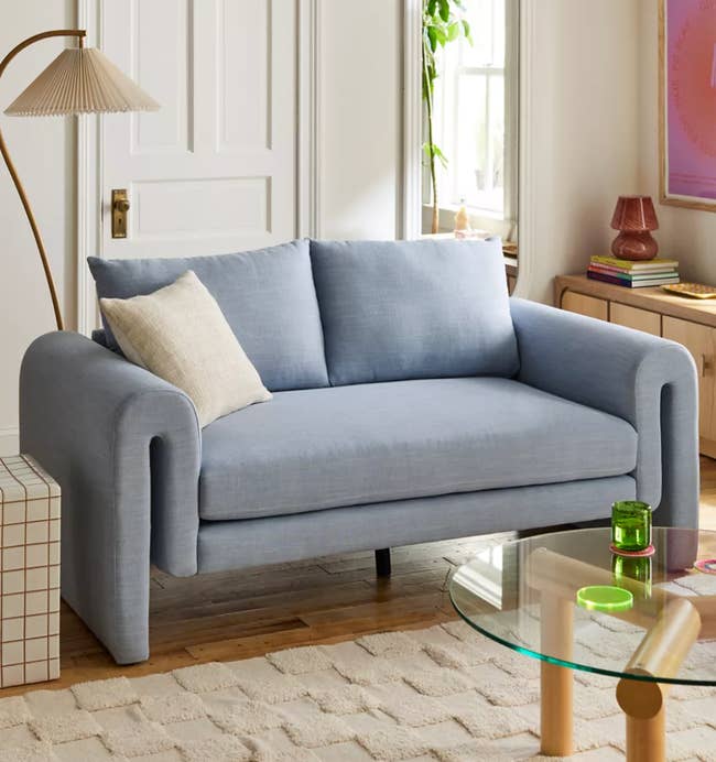 the sky blue mabelle sofa in a living room