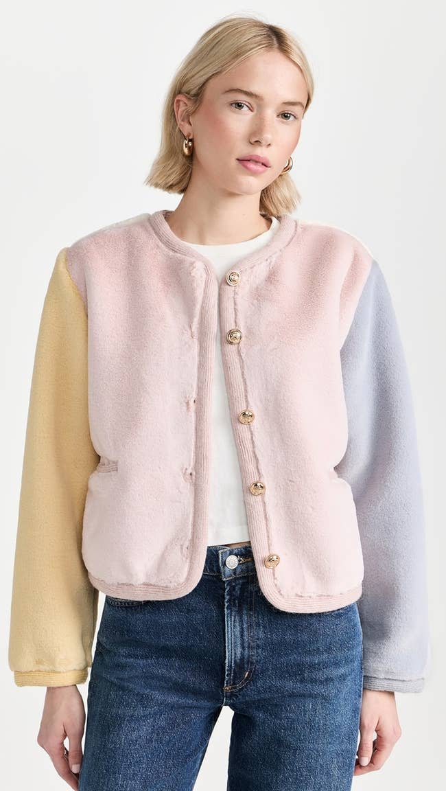 model in yellow pink and periwinkle collarless faux fur jacket with gold buttons