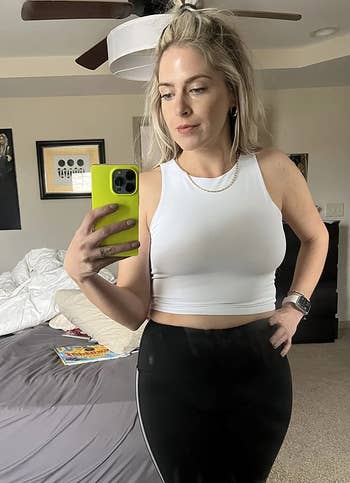 reviewer photo of them wearing a white high-neck bra top