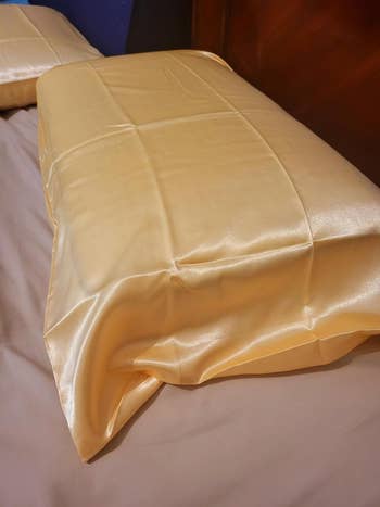 Silky pillowcases shown on a bed