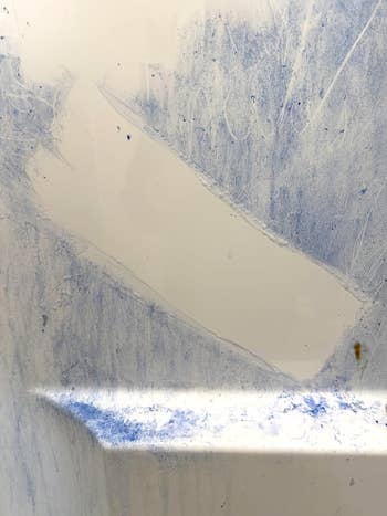 reviewer's ablution  wall, turned bluish  from purple shampoo, with azygous  achromatic  cleanable  spot   swiped done  the mediate  from the magic eraser