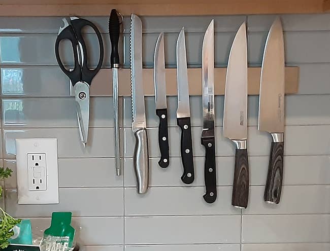 reviewer's strip on a wall holding various knives