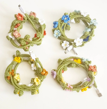four different colored crochet flower vine charging chords