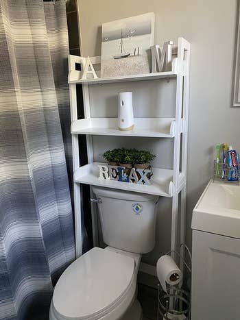 reviewer photo of the white bathroom organizer shelf