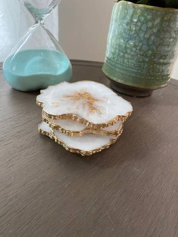 A reviewer's white and gold geode coasters