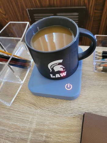 Writer's coffee mug sitting on the warmer