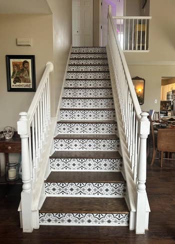 After image of the same staircase with ornate patterned peel and stick stair risers leading to a second floor