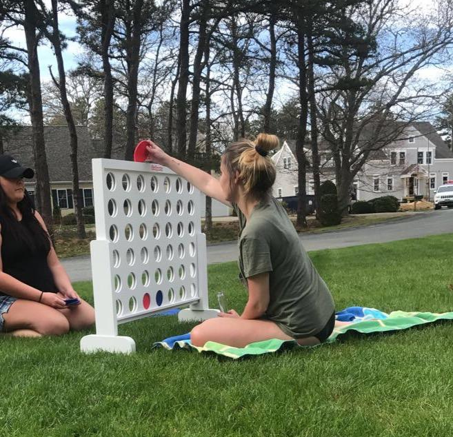 reviewer photo of two people playing 4-in-a-row game outside on grass