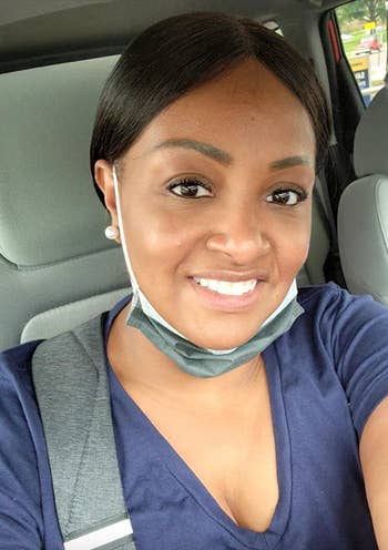 Person successful  a car   taking a selfie, wearing a bluish  apical  and a disguise  nether  their chin