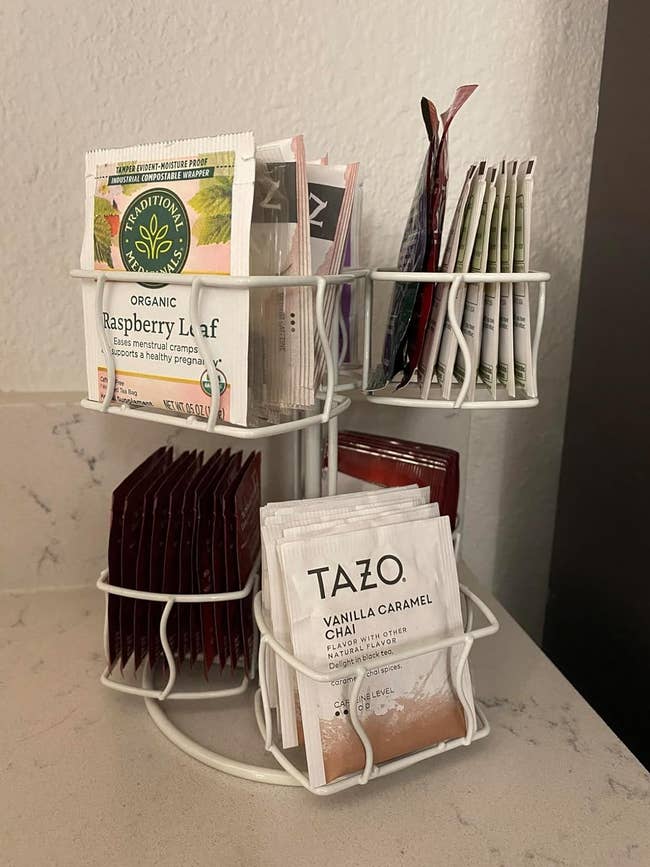 a reviewer's white tea stand with a variety of teas on their counter