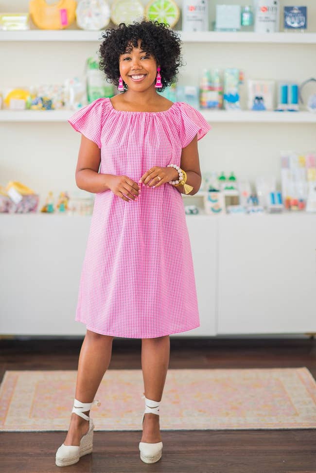 business owner waring the knee-length pink gingham dress with short sleeves on the shoulder