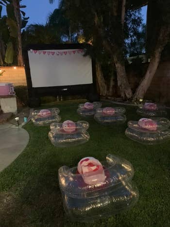 reviewer's backyard movie night set up with projector and inflated seats