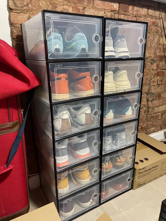 a reviewer's stacked clear shoe boxes