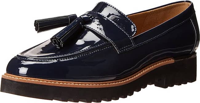 Close up of the loafer in navy with a black sole, 1.38 inch platform, and brown stitching
