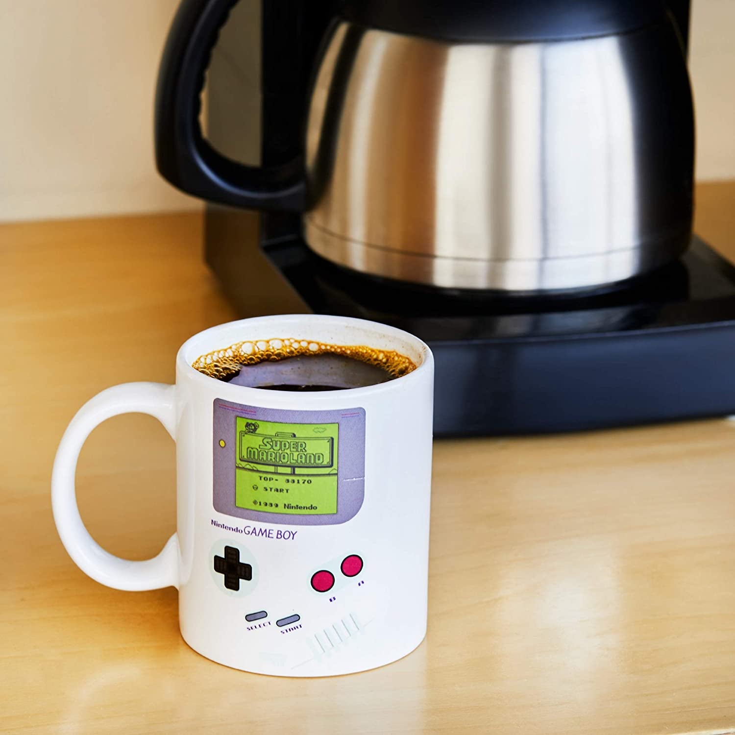 the game boy mug filled with coffee