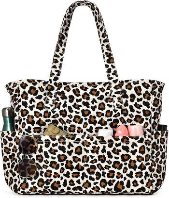 travel Leopard print tote bag with external pockets, holding items like a water bottle and beauty products, suitable for shopping or travel