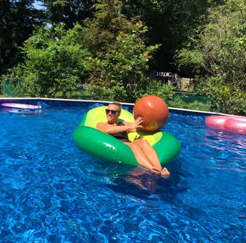 another reviewer floating in the floatie while holding the ball