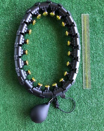 reviewer's black hoop on artificial grass with a ruler for size