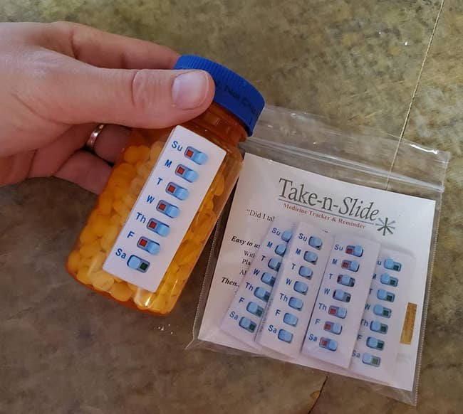a reviewer holding a medication bottle with the tracker on the side