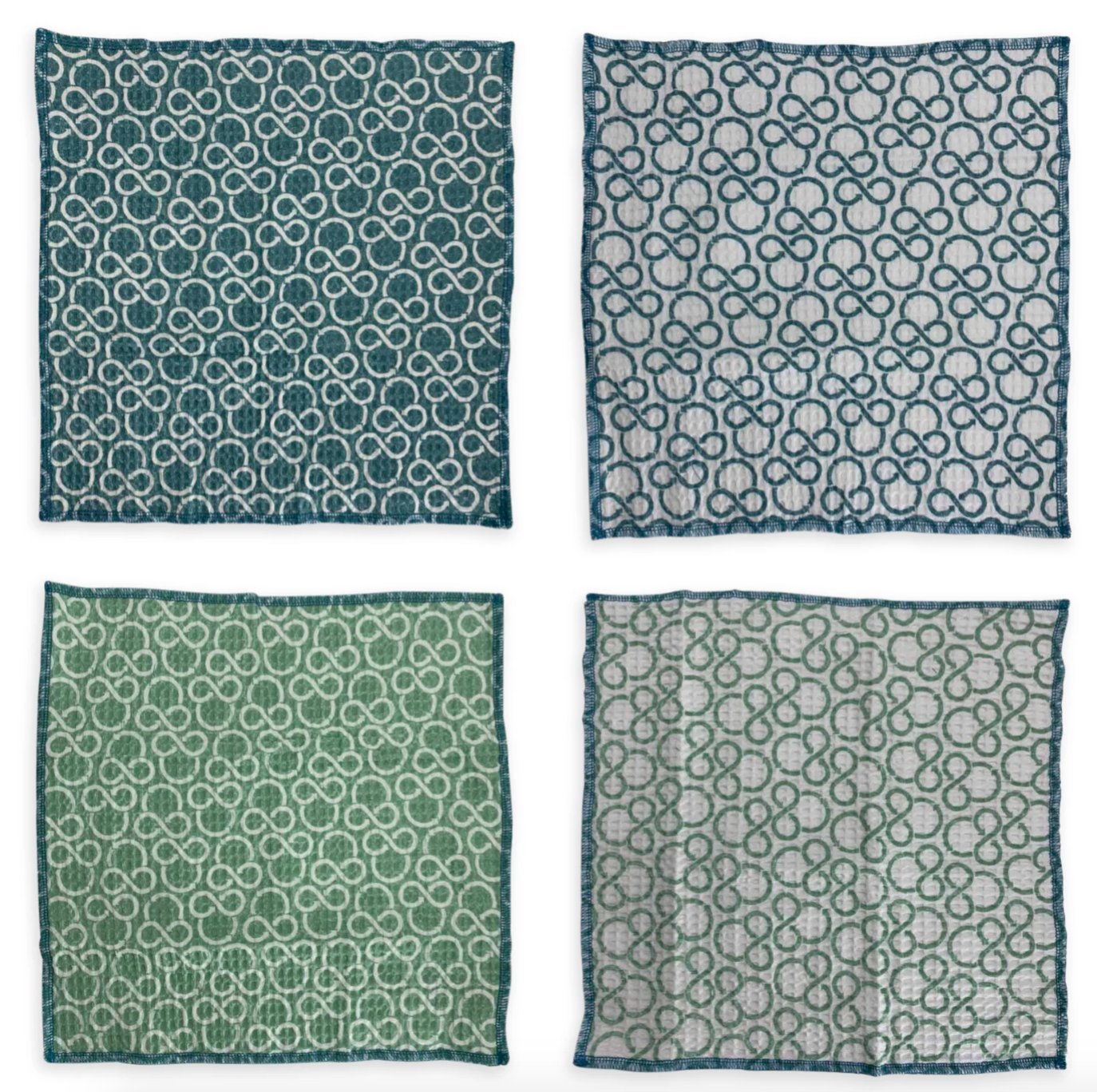 four green and blue wash cloths with subtle mickey recycling symbols on them