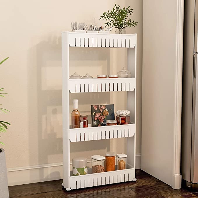 A slim white four-shelved organizer with wheels