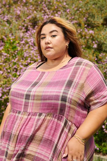 a model in a pink plaid dress