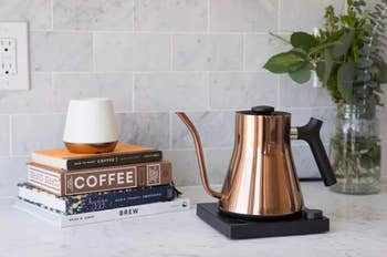 The copper kettle on a black square stand