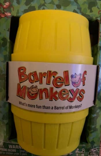 Barrel of Monkeys toy packaging showing a yellow barrel with the text 