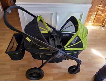 reviewer image of green wagon stroller with awnings open