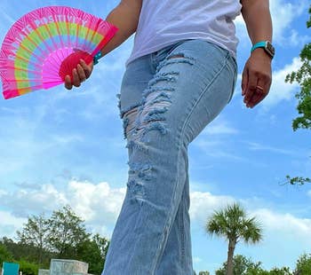 reviewer wearing the pink multicolor sneakers with jeans