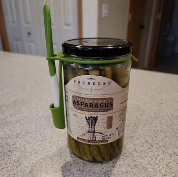 reviewer image of the condiment fork attached to a jar of asparagus