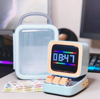 The speaker next to its carrying case.