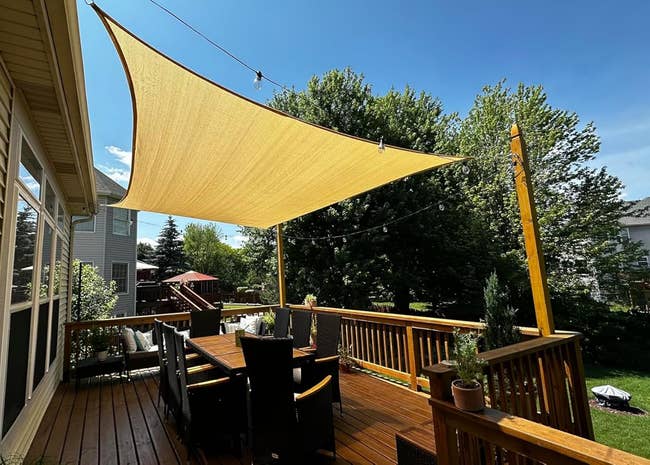 Outdoor patio with a ample triangular shadiness sail overhead