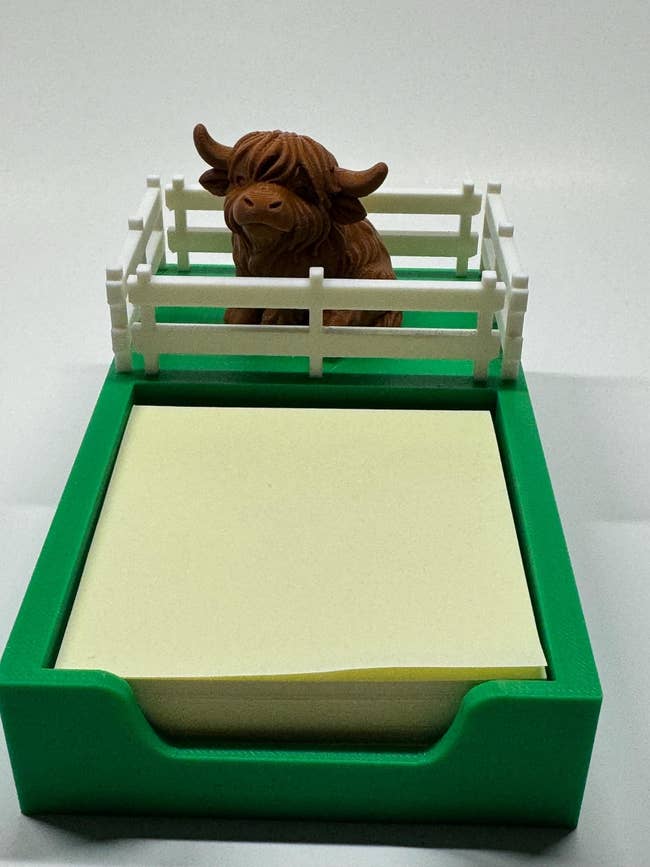 Highland cattle  enactment      holder with greenish  basal  and achromatic  fence, containing yellowish  sticky notes