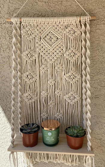 Reviewer image of hanger on wall with plants and a candle