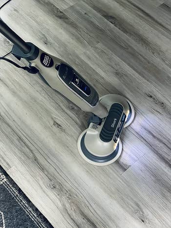 the shark steam mop being used on a floor