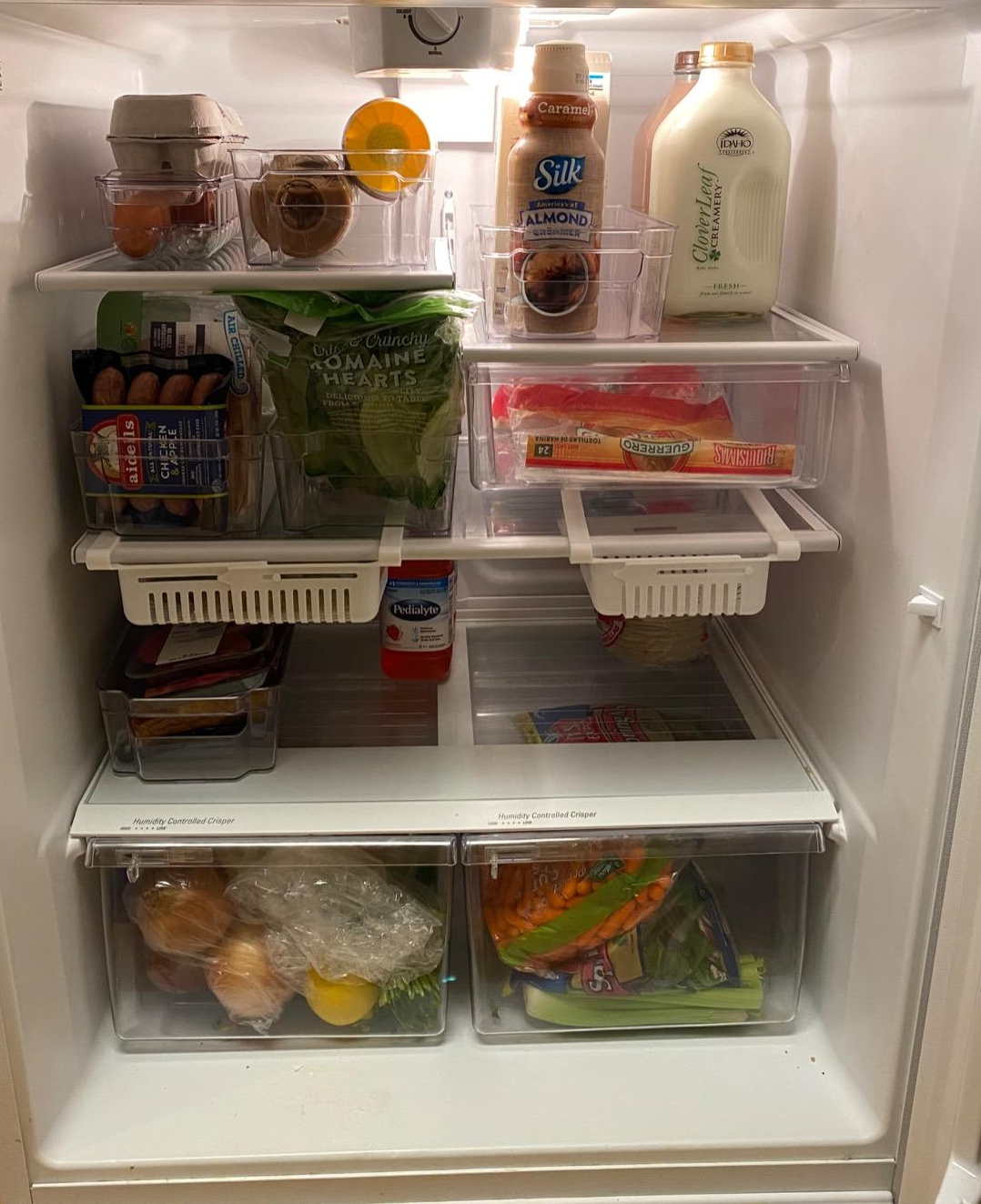 a reviewer's fridge organized with the clear bins