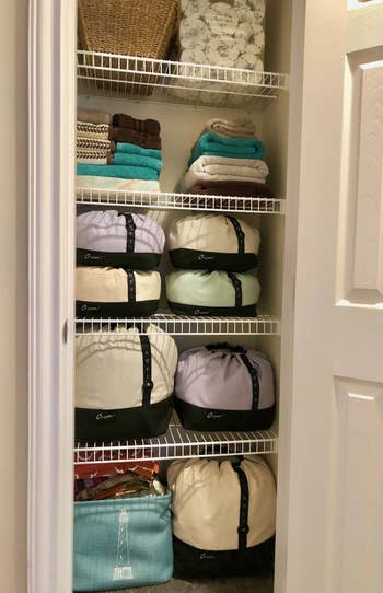 a closet with multiple O-Sheet bedding holders inside