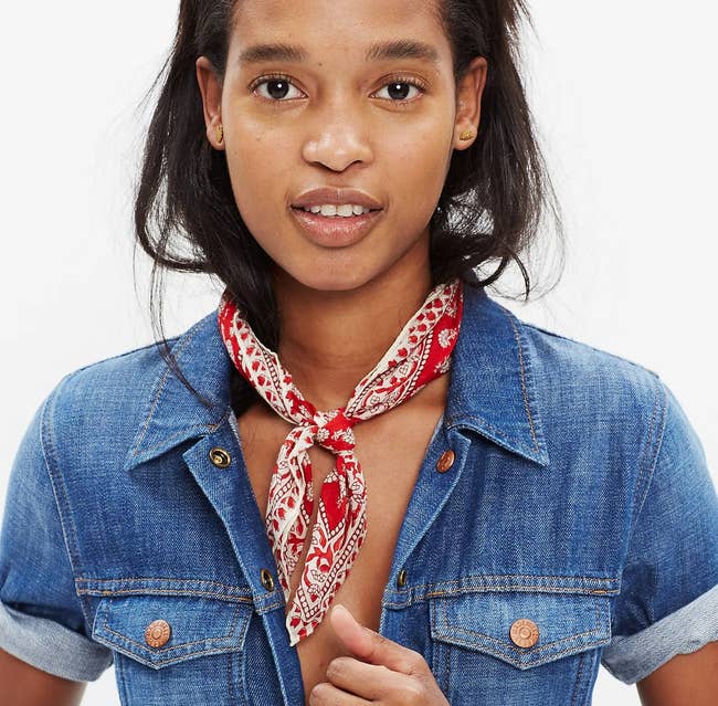 a model with a red print bandana around their neck