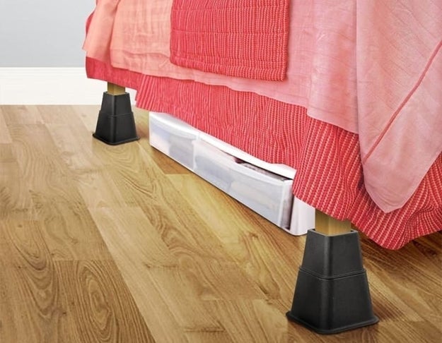 the bed risers creating additional under bed storage space for clothing storage