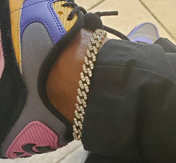 Reviewer wearing the gold chain ankle bracelet