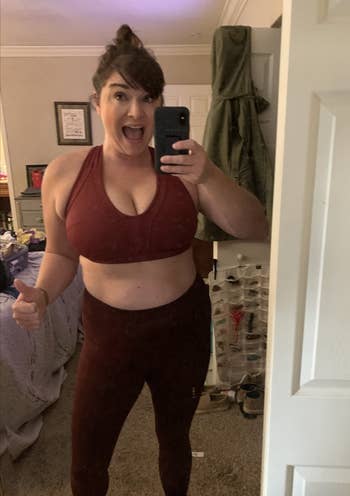 Reviewer showing the front of v-neck bra in red 