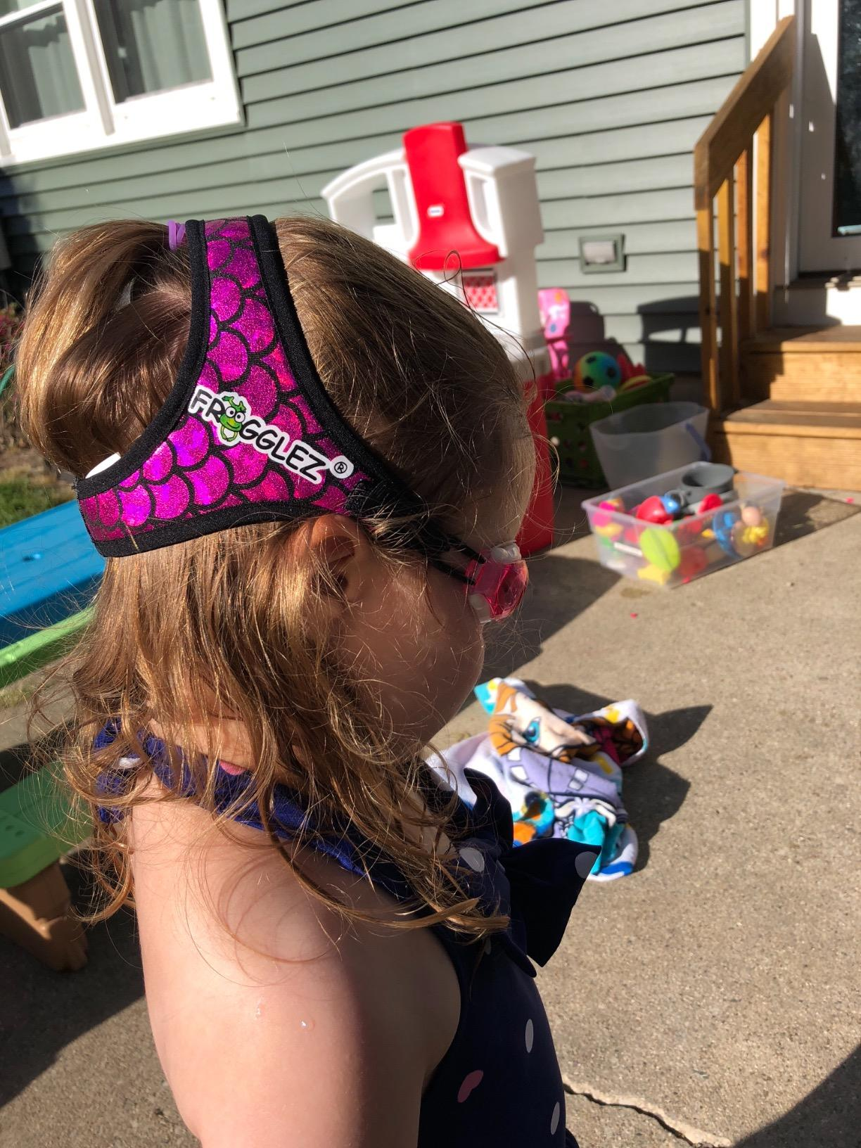 reviewer's young child wearing Frogglez swim goggles