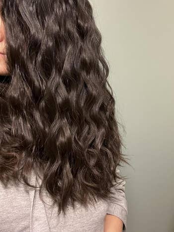 Reviewer with shiny, wavy, shoulder-length hair