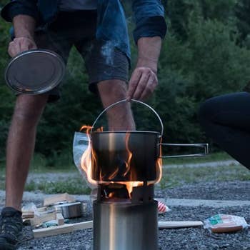 camper cooking with the camp stove and pot