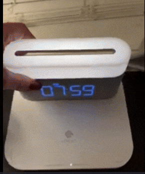 Reviewer removing the clock from the interface and tapping the light on top 