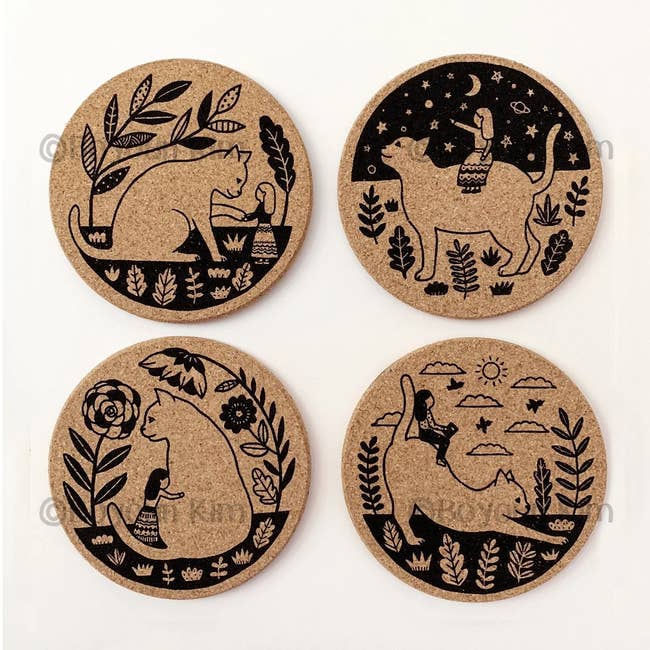 the set of four cork coasters with black cat designs on them
