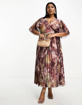 model wearing the brown and pink pleated midi dress