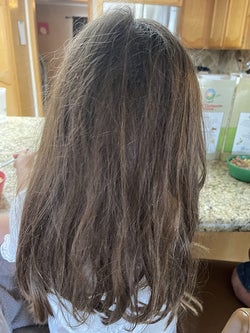 Reviewer's before photo of their child with knotted hair
